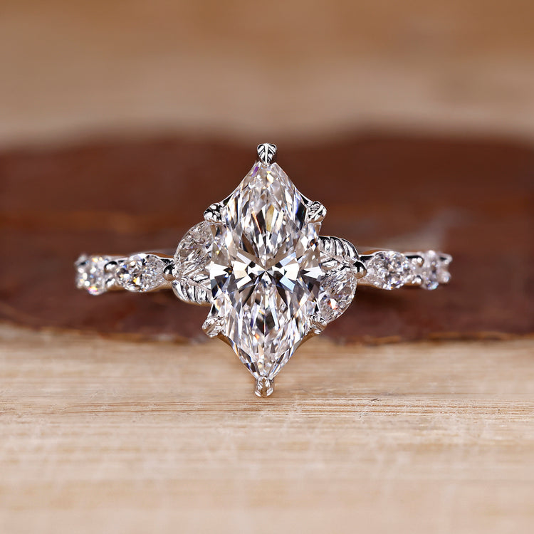 Marquise cut diamond ring in white gold with nature inspired design.

