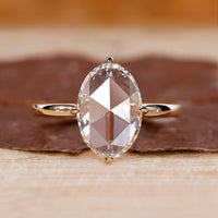 Oval rose cut engagement ring set in yellow gold with a solitaire setting.
