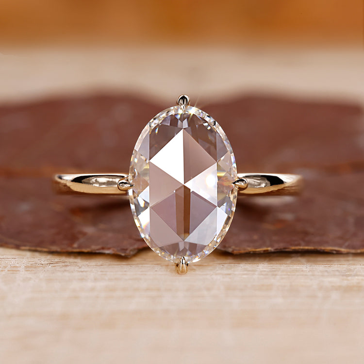 Oval rose cut engagement ring set in yellow gold with a solitaire setting.
