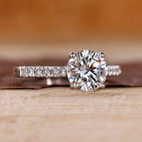 Round diamond engagement ring set in a handcrafted white gold band.
