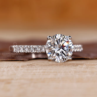 Round diamond engagement ring set in a handcrafted white gold band.
