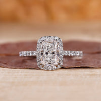 Elongated cushion cut diamond ring in a delicate setting.
