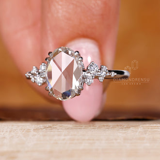 White gold ring with oval rose cut diamond and double claw prong.
