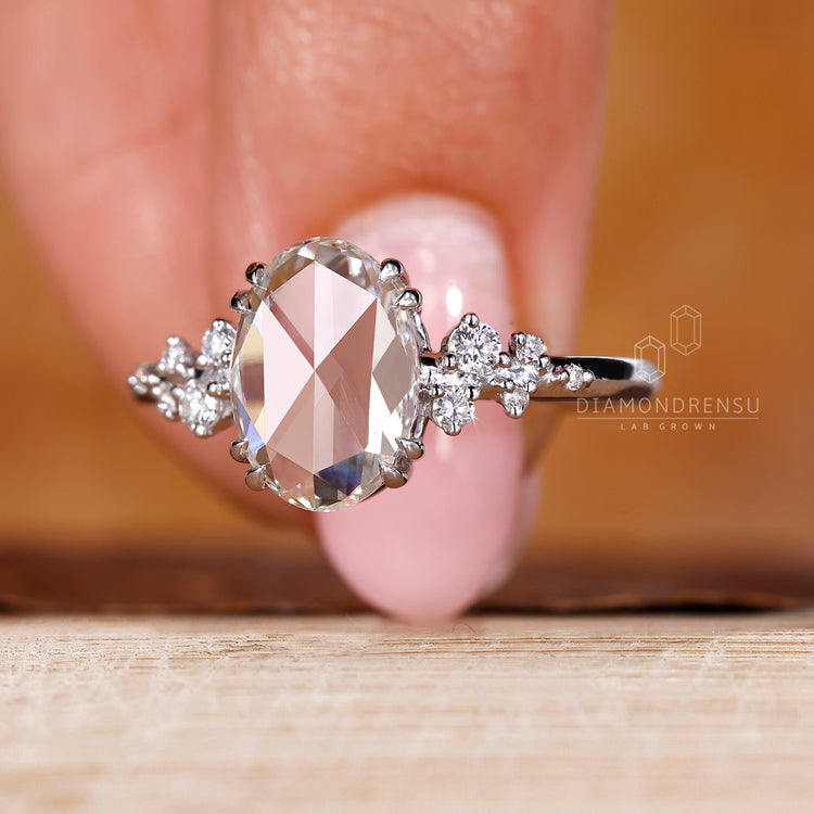 White gold ring with oval rose cut diamond and double claw prong.
