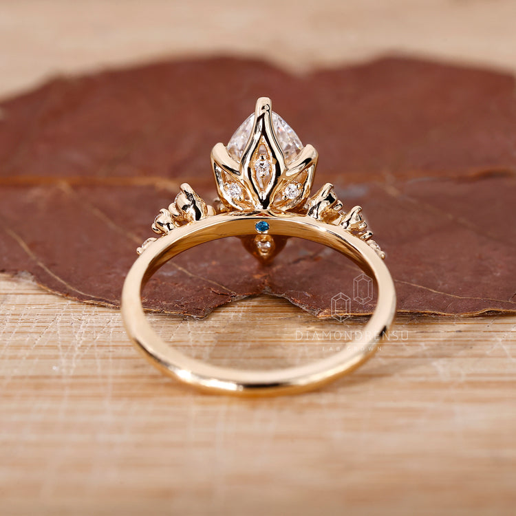 Lab grown diamond set in a marquise cut engagement ring with 6 claw prong setting and yellow gold engagement ring.
