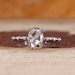 Oval rose cut diamond ring with distance pave setting in white gold.
