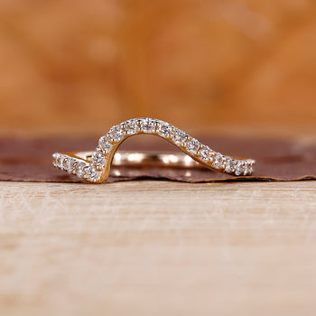 An ocean wave wedding band with flowing design
