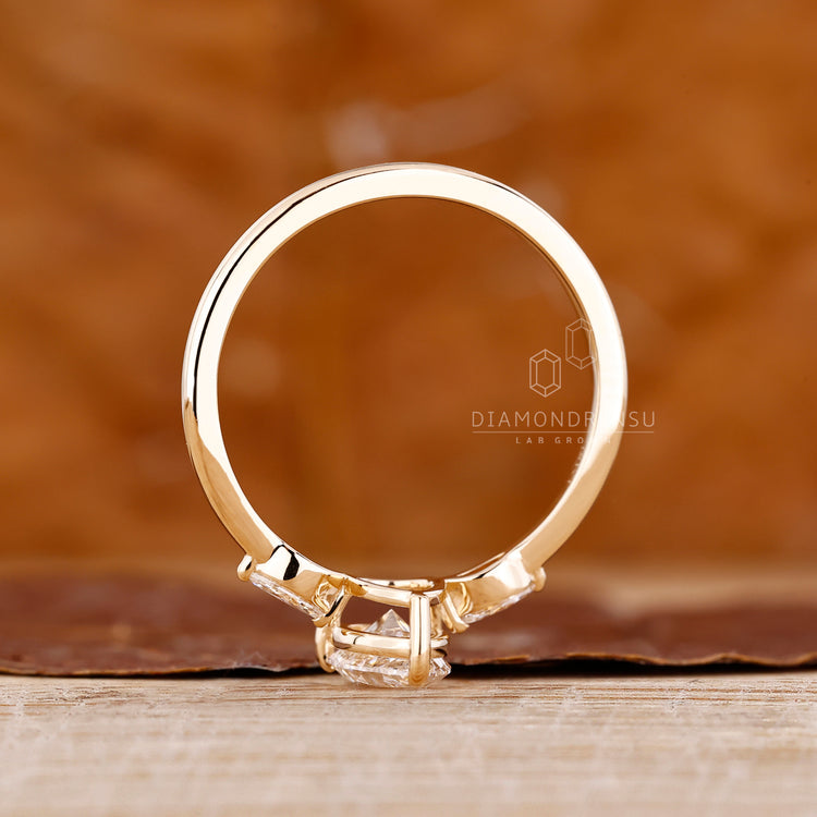 IGI certified handmade ring featuring pear center diamond and side diamonds.
