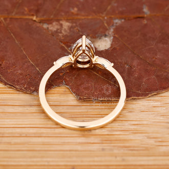 Buy engagement ring with pear center diamond and marquise side diamonds.
