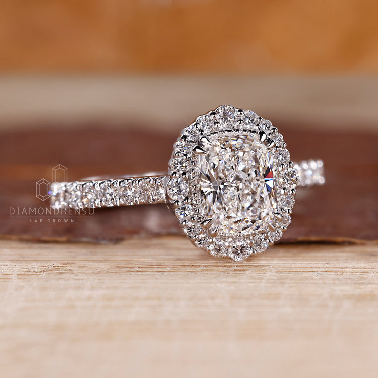 IGI certified elongated cushion engagement ring with halo and pave accents.
