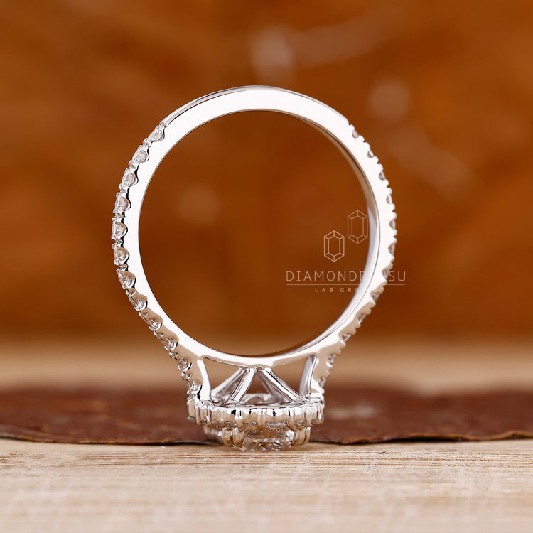 Diamondrensu engagement ring with cathedral setting and milgrain detailing.
