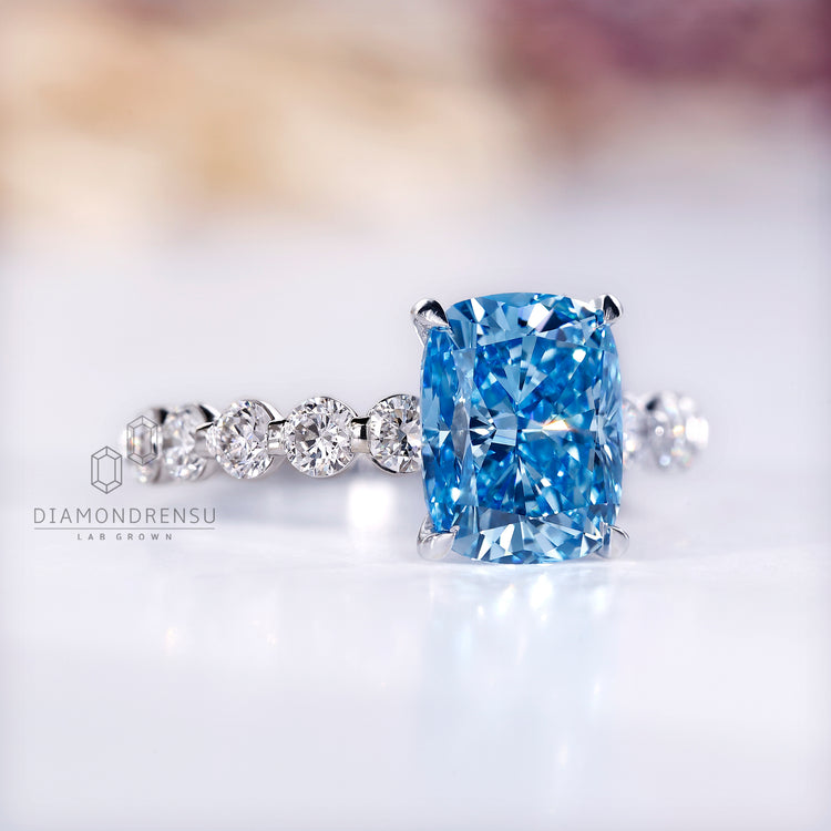 Round cut pave band ring with blue diamond and custom design.
