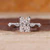 Radiant cut diamond ring with hidden halo in white gold setting.
