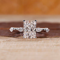Radiant cut diamond ring with hidden halo in white gold setting.
