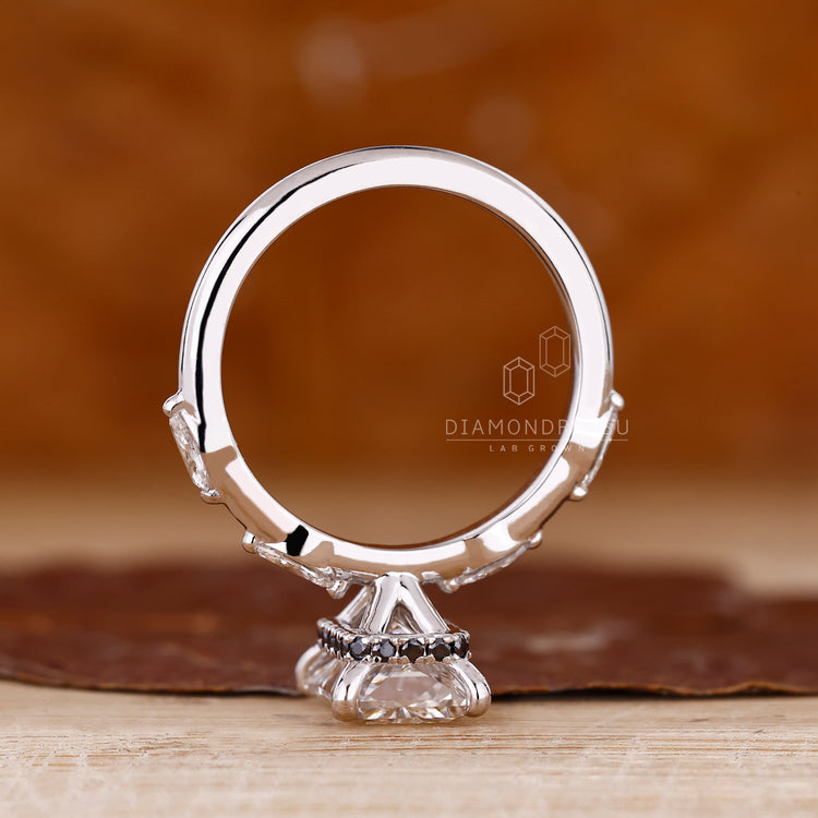 Four prong setting ring holding radiant cut diamond and hidden halo securely.
