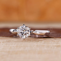 White gold ring with round diamond solitaire and custom design.
