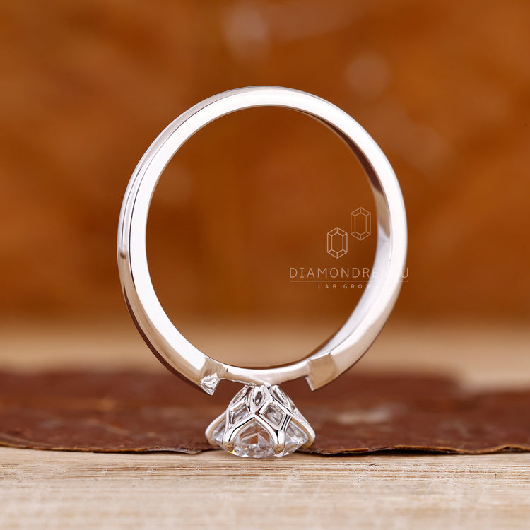 Custom diamond ring featuring round diamond solitaire with tapered shank.
