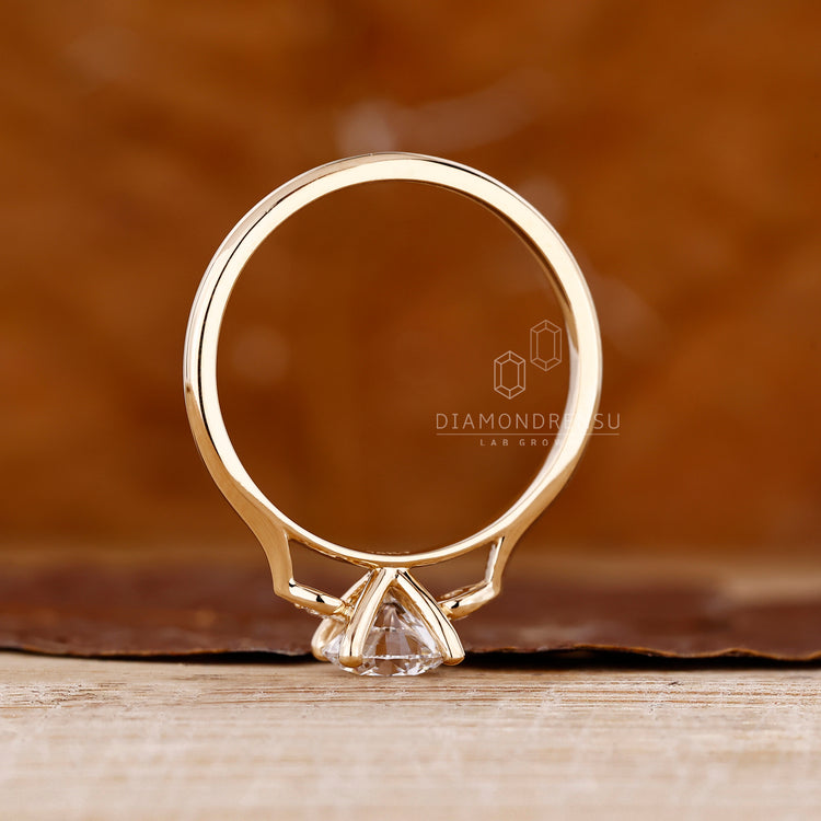 Custom engagement ring in yellow gold with 4 prong secure setting.
