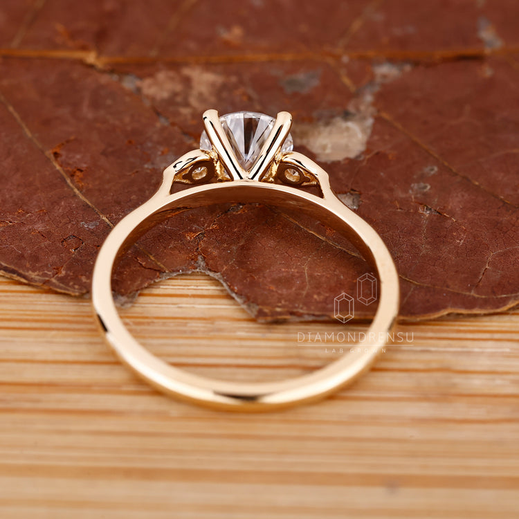 Lab Grown Diamond round diamond ring with cathedral and three stone design.
