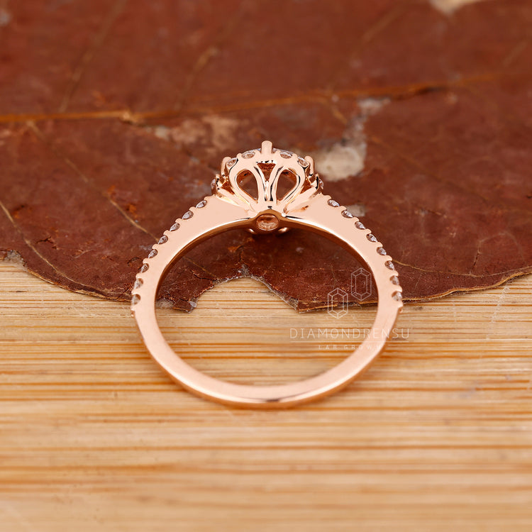 Round cut halo diamond ring in rose gold handmade jewelry.
