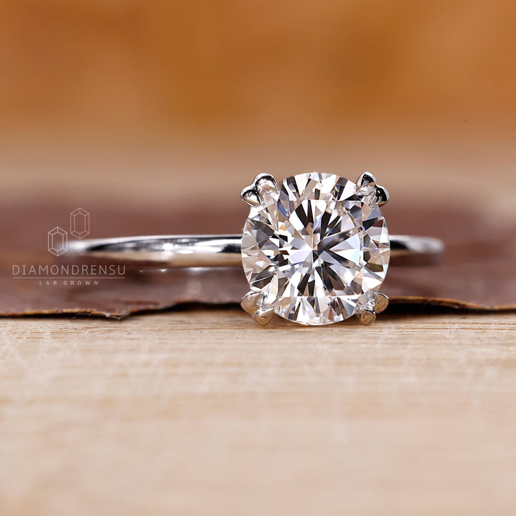 White gold engagement ring with round cut solitaire diamond.
