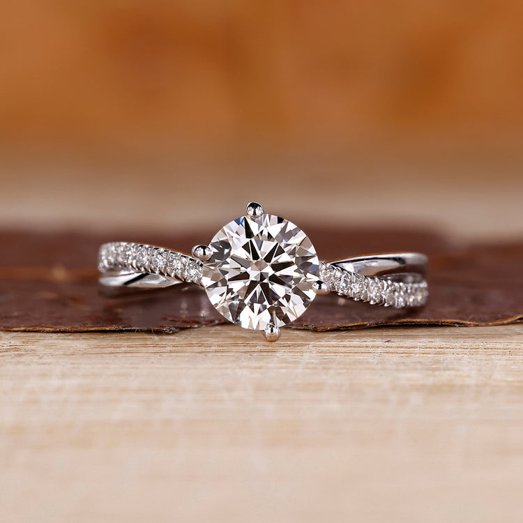 Round diamond ring with a twisted pave band and 4 prong setting.
