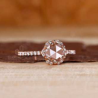 Halo diamond ring with round cut rose cut diamonds in gold.
