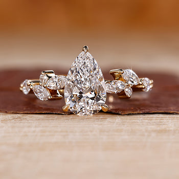 Pear cut engagement ring with a leaf style ring design.
