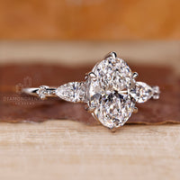 Tapered shank ring with oval cut diamond and five stone setting.
