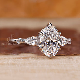 Tapered shank ring with oval cut diamond and five stone setting.
