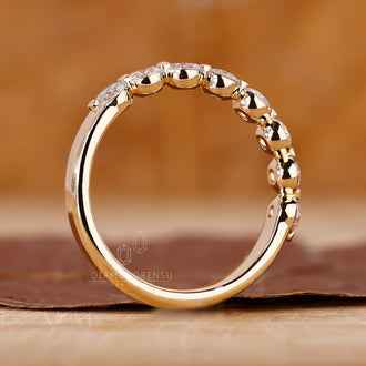 Round diamond wedding band with shared prong setting.
