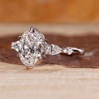 Six claw prong ring holding oval cut diamond and side diamonds securely.
