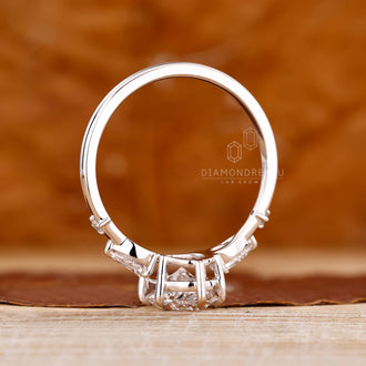 Buy engagement ring with oval cut diamond and pear round side stones.
