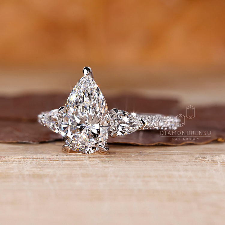 Cathedral setting ring featuring pear cut diamond and custom handmade design.
