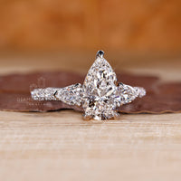 3 side pave setting ring with pear cut diamond and handmade jewelry.

