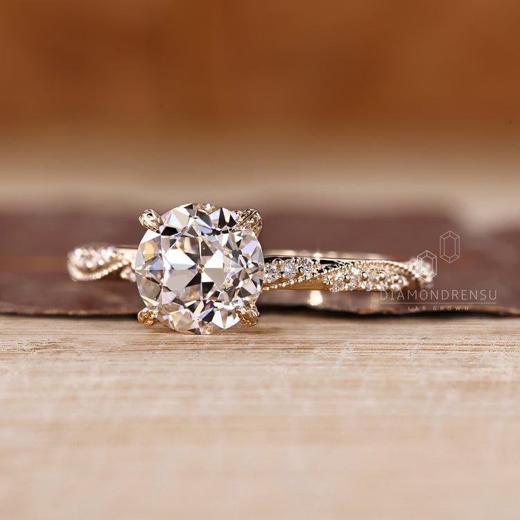 Round old European cut ring with four leaf prong and pave setting.
