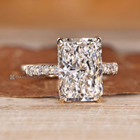 Hidden halo with round stones and four claw prong setting.