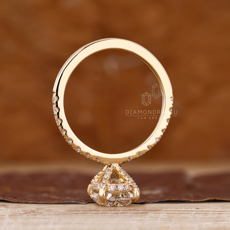 Handmade oval cut ring with round cut pave band and hidden accents.