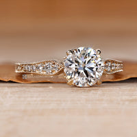 Handmade round cut diamond ring with four claw prongs.