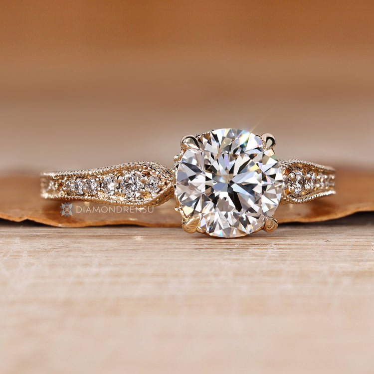 Handmade round cut diamond ring with four claw prongs.