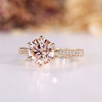 Six prong setting secures the pink center stone.