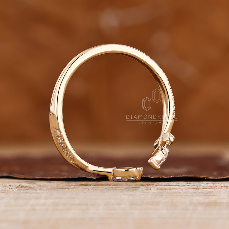 Handmade wedding band with marquise and round diamond details.