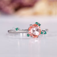 IGI certified round rose cut diamond ring with emerald side gemstones.