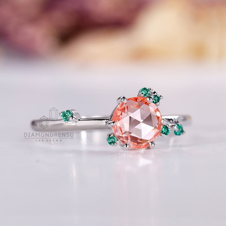 IGI certified round rose cut diamond ring with emerald side gemstones.