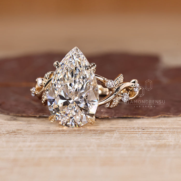 Pear shaped diamond ring in four leaf style prong setting.
