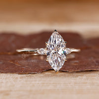 Tulip setting marquise diamond ring with pear side stones.