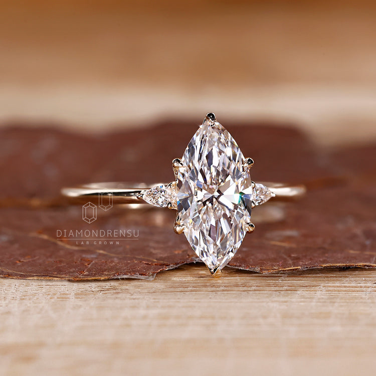 Tulip setting marquise diamond ring with pear side stones.