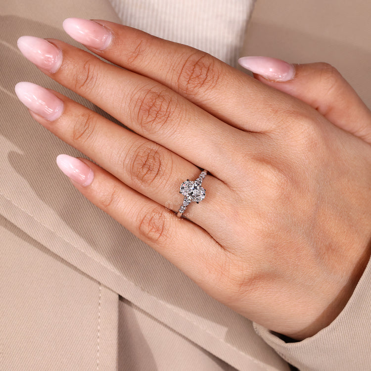 Handmade oval cut diamond engagement ring with cathedral and side stones.