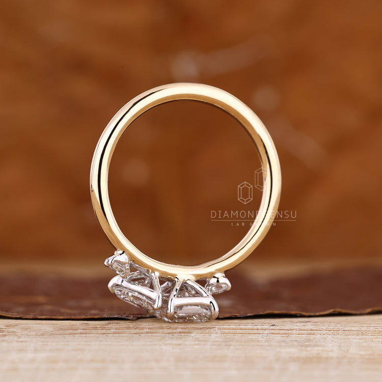 Handmade two stone ring with pear and radiant cut diamonds and side stones.