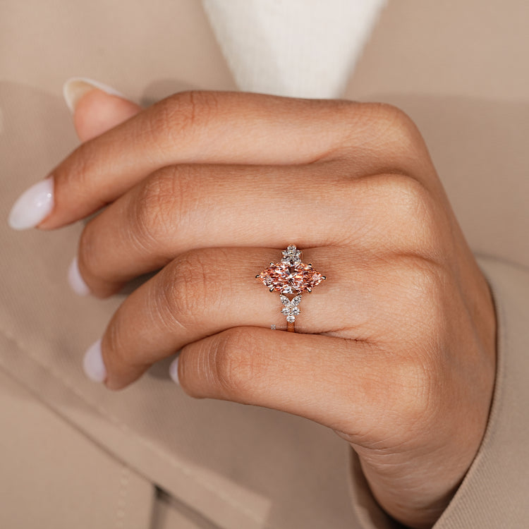 Cluster setting engagement ring with pink center diamond.